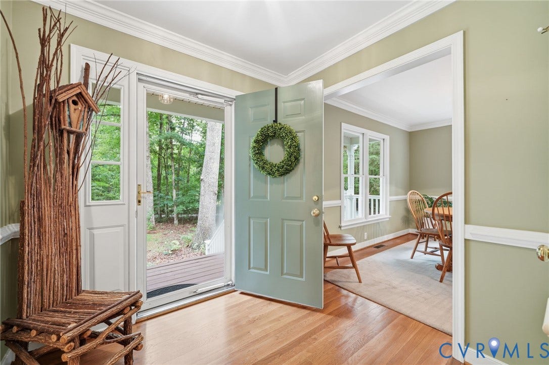 1902 Soldiers Lane, Crozier, VA 23039 Entryway featuring wood-finish flooring, a light blue door, and an open doorway to an interior room