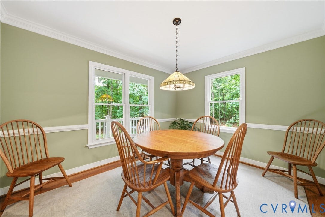 1902 Soldiers Lane, Crozier, VA 23039 Dining area featuring multiple windows, crown molding, chair rail molding, a suspended ceiling light fixture, and light-colored carpeting