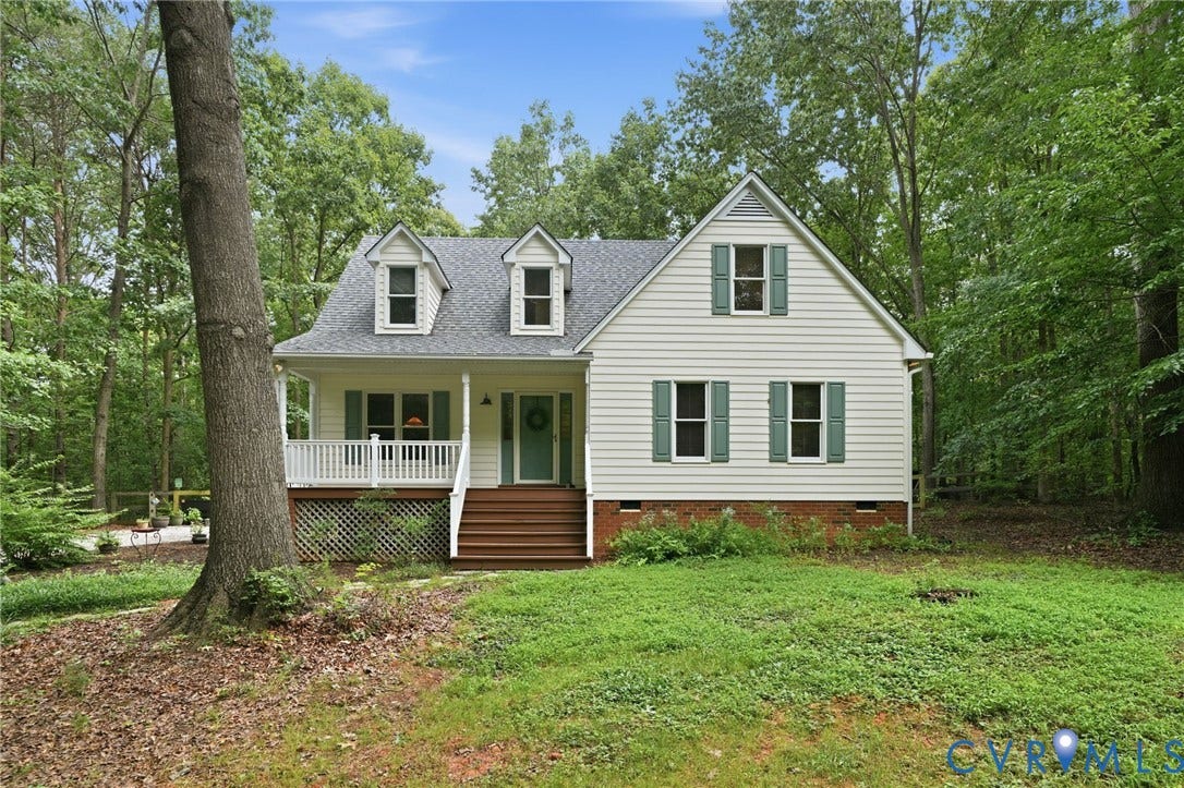 1902 Soldiers Lane, Crozier, VA 23039 Charming Cape Cod style residence featuring light-colored siding, a dark gray shingle roof, and multiple dormer windows