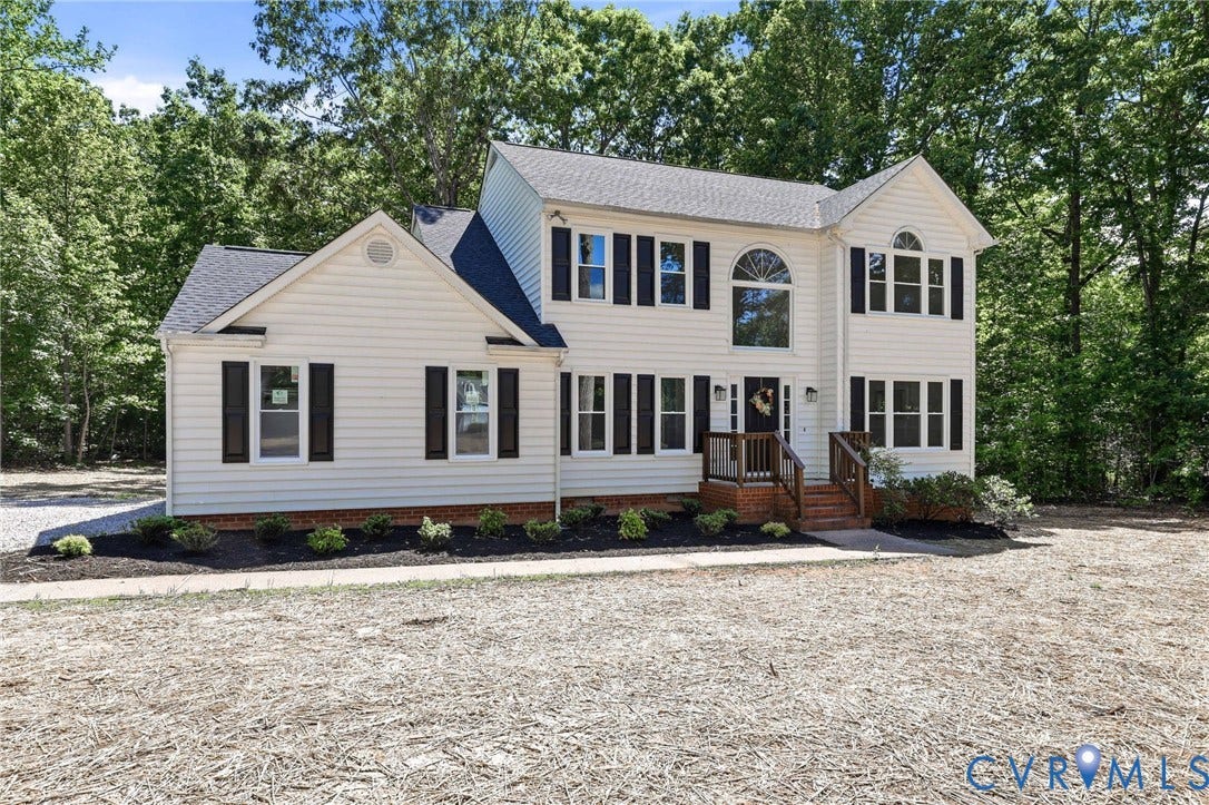 3457 Richards Run, Very Desirable!, Powhatan, VA 23139 Two-story residence featuring light-colored siding, dark shutters, and a prominent arched window above the entry