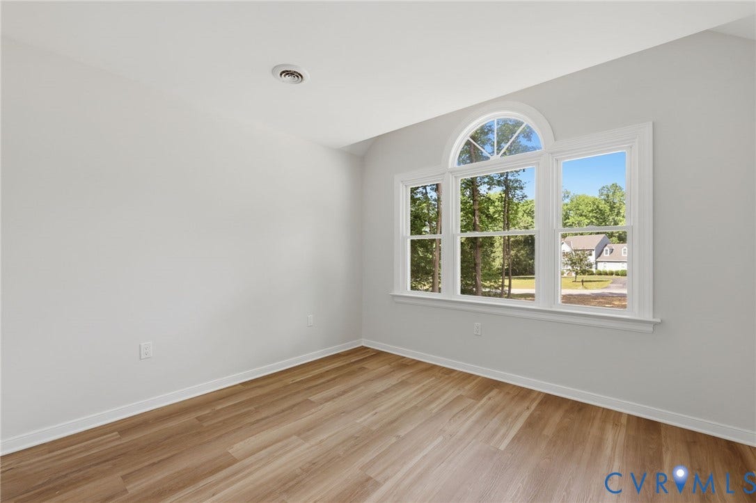 3457 Richards Run, Very Desirable!, Powhatan, VA 23139 Room featuring a multi-pane window with an arched transom, wood-finish flooring, white baseboards, and light gray walls