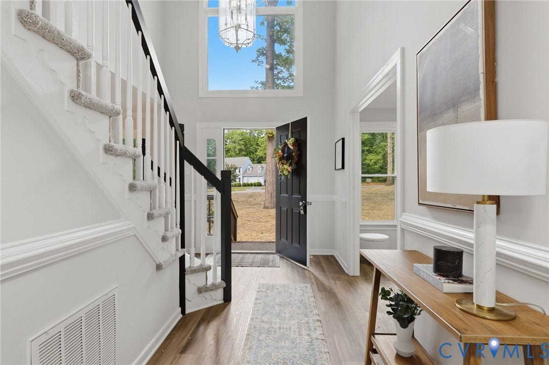 3457 Richards Run, Very Desirable!, Powhatan, VA 23139 Double-height entryway featuring wood-finish flooring, a white staircase with black newel posts and handrail, and an arched transom window