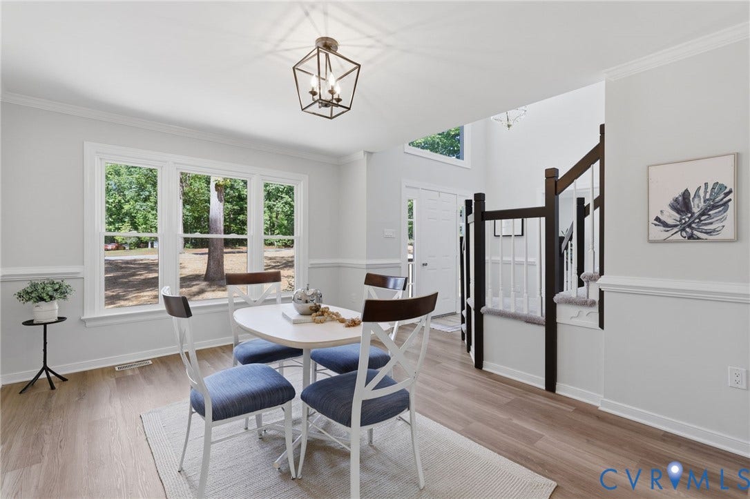 3457 Richards Run, Very Desirable!, Powhatan, VA 23139 Bright dining area featuring wood-finish flooring, a contemporary light fixture, and a large window array