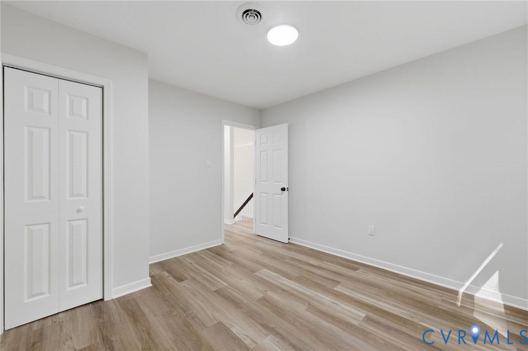 3457 Richards Run, Very Desirable!, Powhatan, VA 23139 Room featuring wood-finish flooring, light gray walls, white trim, a flush-mount ceiling light, and a bi-fold closet door
