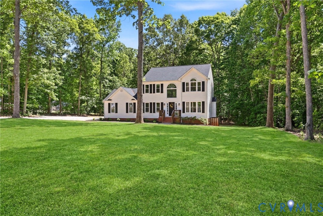 3457 Richards Run, Very Desirable!, Powhatan, VA 23139 Spacious front lawn with a traditional-style home featuring white siding, dark shutters, a prominent arched window, and a dark shingle roof