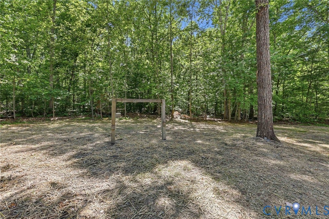 3457 Richards Run, Very Desirable!, Powhatan, VA 23139 Wooded grounds with extensive tree cover, featuring a wooden frame structure