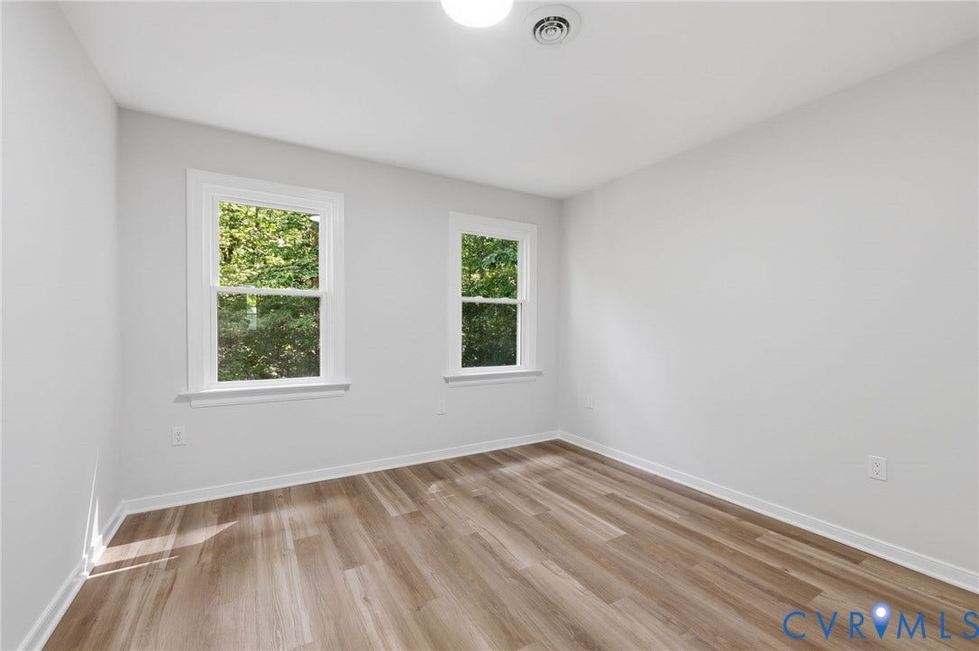 3457 Richards Run, Very Desirable!, Powhatan, VA 23139 Bright interior featuring wood-finish flooring, white baseboards, two double-hung windows, and a ceiling-mounted light fixture with a vent