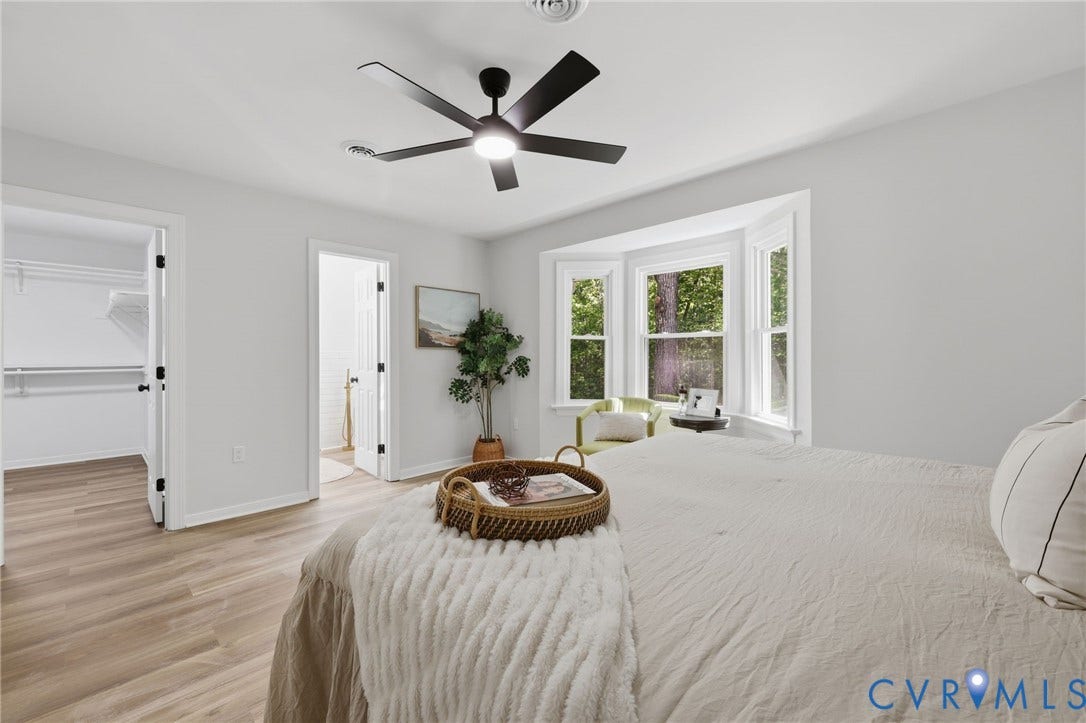 3457 Richards Run, Very Desirable!, Powhatan, VA 23139 Bedroom featuring wood-finish flooring, a bay window with natural light, a ceiling fan with integrated lighting, an open doorway to a walk-in closet with shelving, and an additional doorway