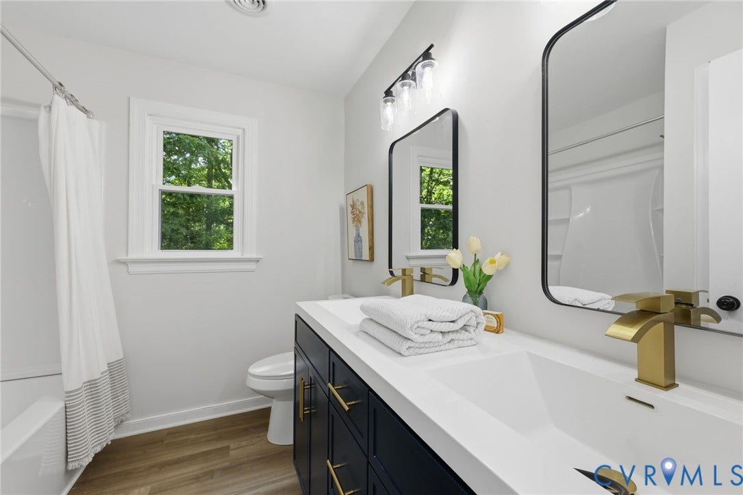 3457 Richards Run, Very Desirable!, Powhatan, VA 23139 Bathroom featuring a dual vanity with integrated sinks, black cabinetry, gold-finish hardware, and a tub/shower combination