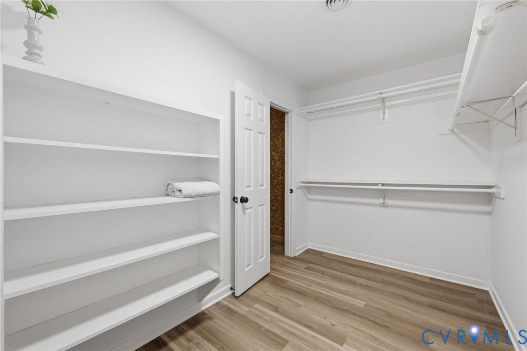 3457 Richards Run, Very Desirable!, Powhatan, VA 23139 White-painted interior featuring wood-finish flooring, built-in shelving, and white hanging rods