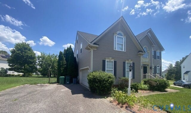 6521 Oakland Chase Place, Henrico, VA 23231 Two-story residence featuring a gabled roofline, siding exterior, attached two-car garage, and established front landscaping