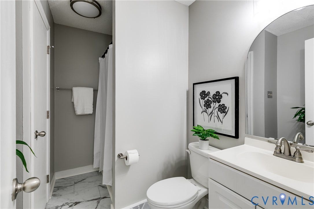 2825 Ashley Glen Drive, Henrico, VA 23233 First floor full bathroom with new flooring.