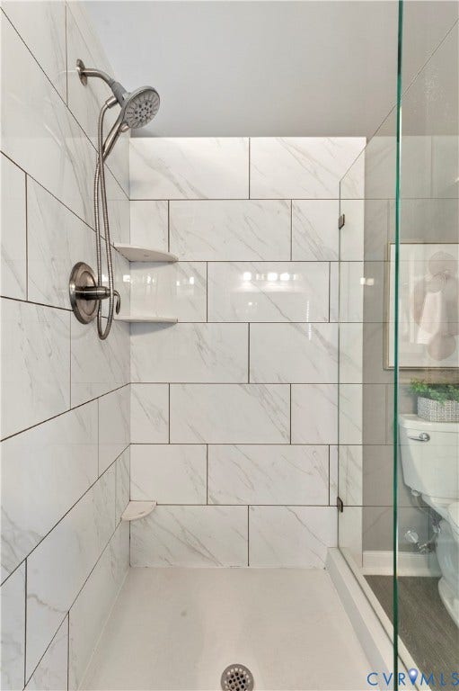 5117 Hart Mill Drive, Glen Allen, VA 23060 Walk-in shower featuring white subway tile surround, clear glass enclosure, and a brushed nickel shower fixture