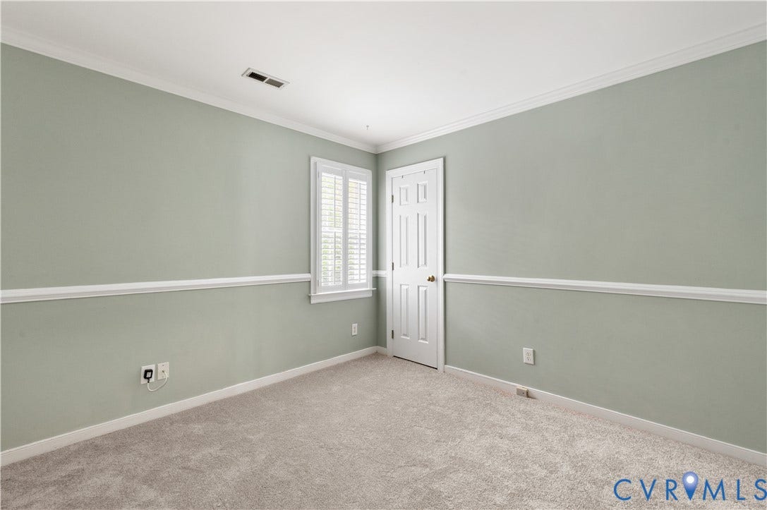 5117 Hart Mill Drive, Glen Allen, VA 23060 Carpeted room featuring light green walls with white chair rail molding, a white paneled door, and a window with white plantation shutters