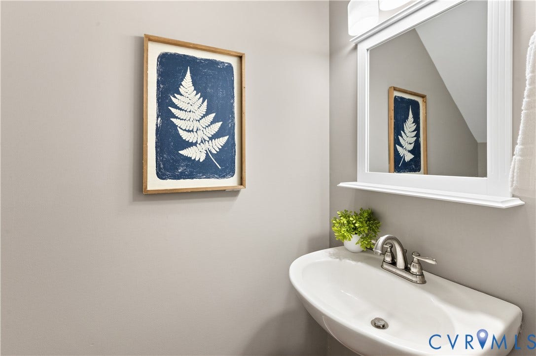 5117 Hart Mill Drive, Glen Allen, VA 23060 Pedestal sink with brushed nickel faucet, framed wall mirror, and neutral wall paint