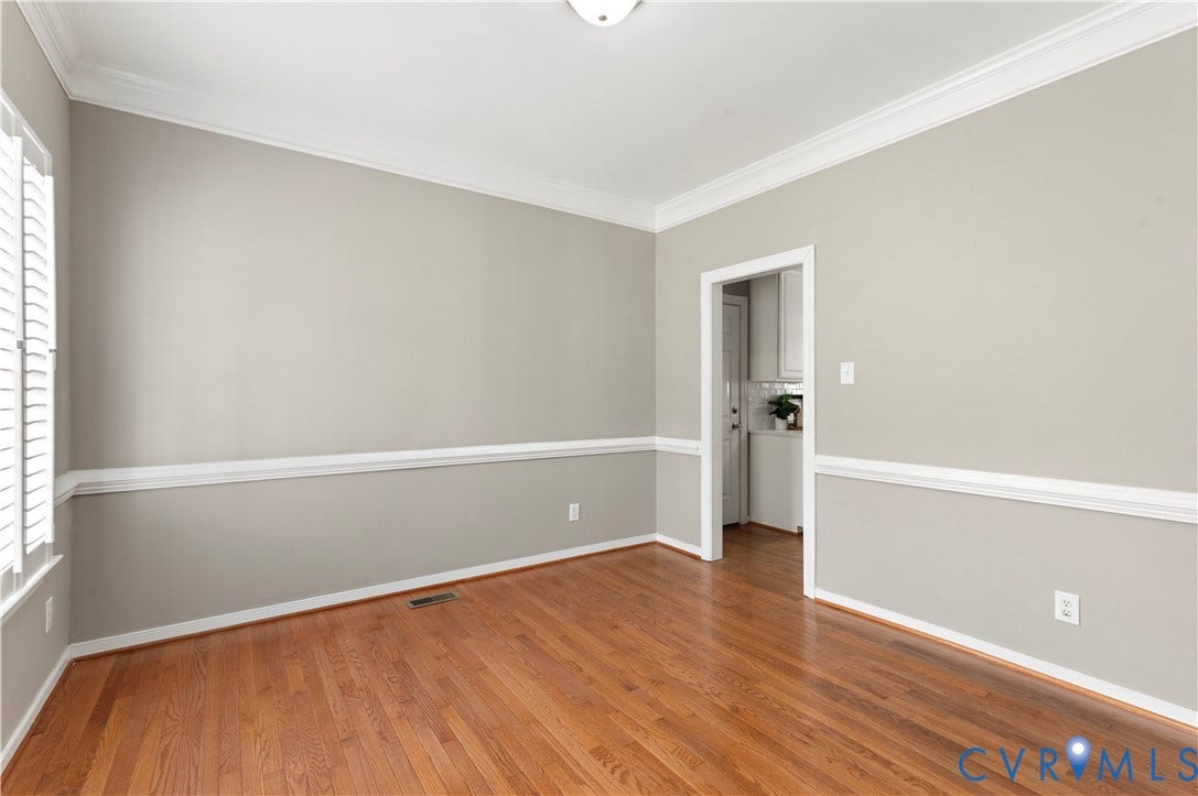 5117 Hart Mill Drive, Glen Allen, VA 23060 Wood-finish flooring throughout, featuring crown molding, chair rail detailing, recessed doorway, and window with plantation shutters