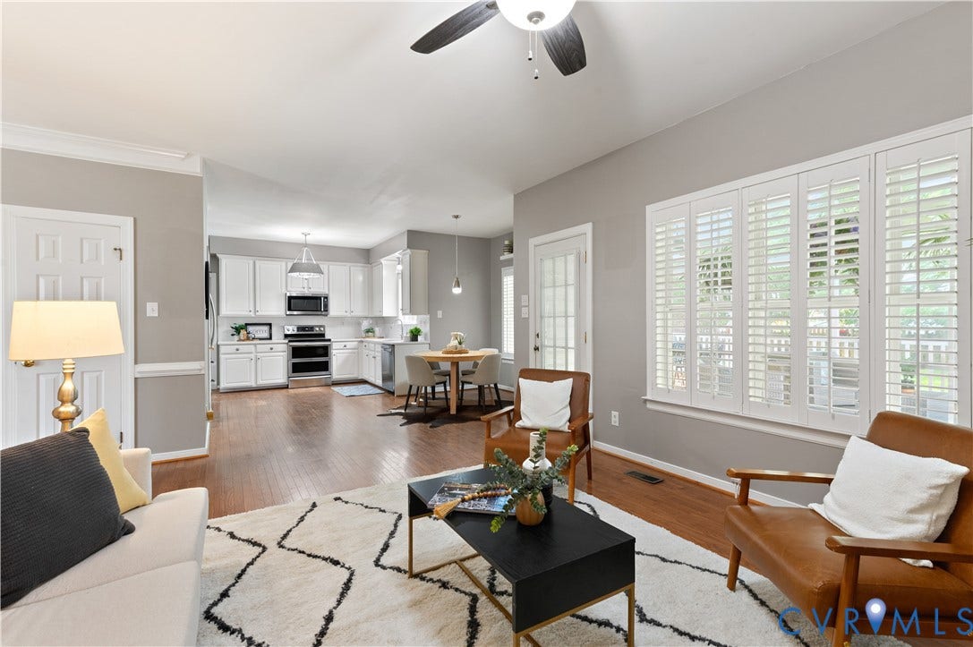 5117 Hart Mill Drive, Glen Allen, VA 23060 Open-concept living space featuring wood-finish flooring, a contemporary ceiling fan, and extensive natural light through multiple windows