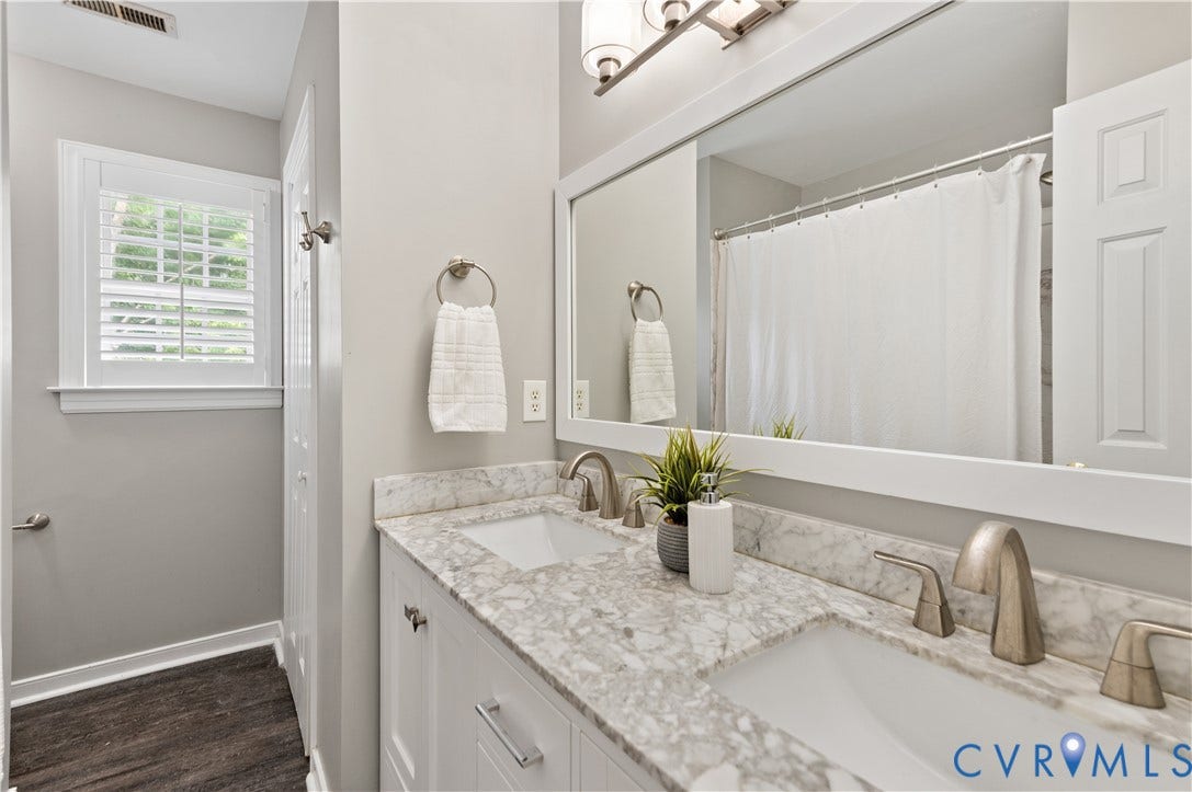 5117 Hart Mill Drive, Glen Allen, VA 23060 Double vanity with dual undermount sinks, stone countertop, and brushed nickel hardware