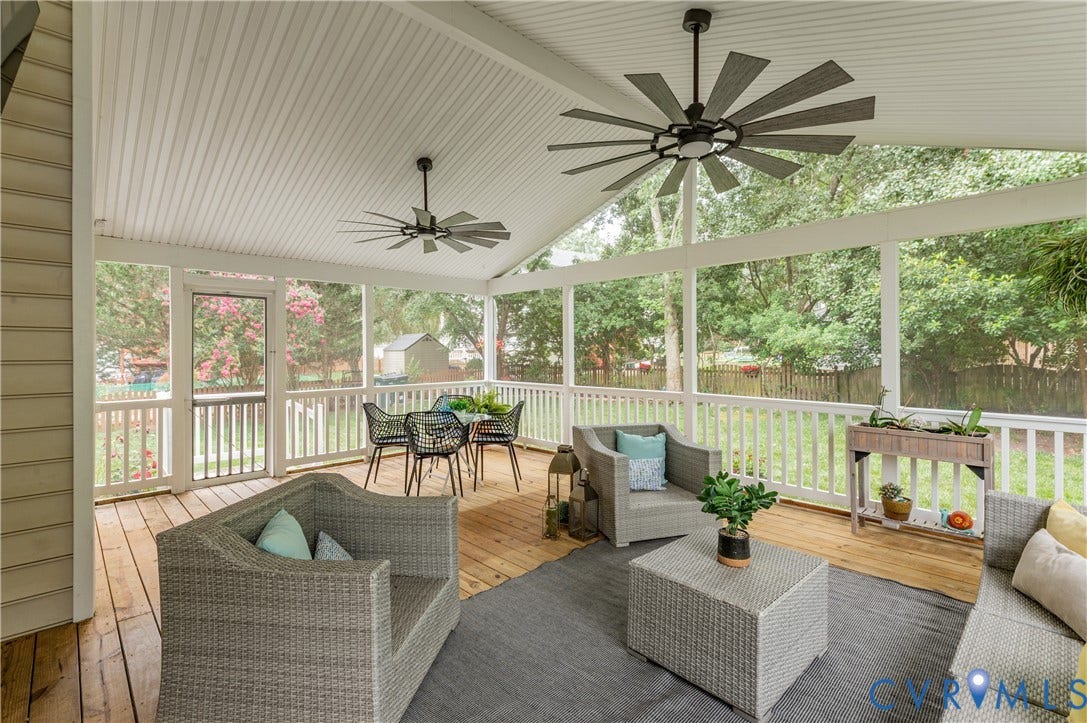 5117 Hart Mill Drive, Glen Allen, VA 23060 Expansive screened porch featuring a vaulted beadboard ceiling, two ceiling fans with integrated lighting, wood-finish flooring, and white baluster railing