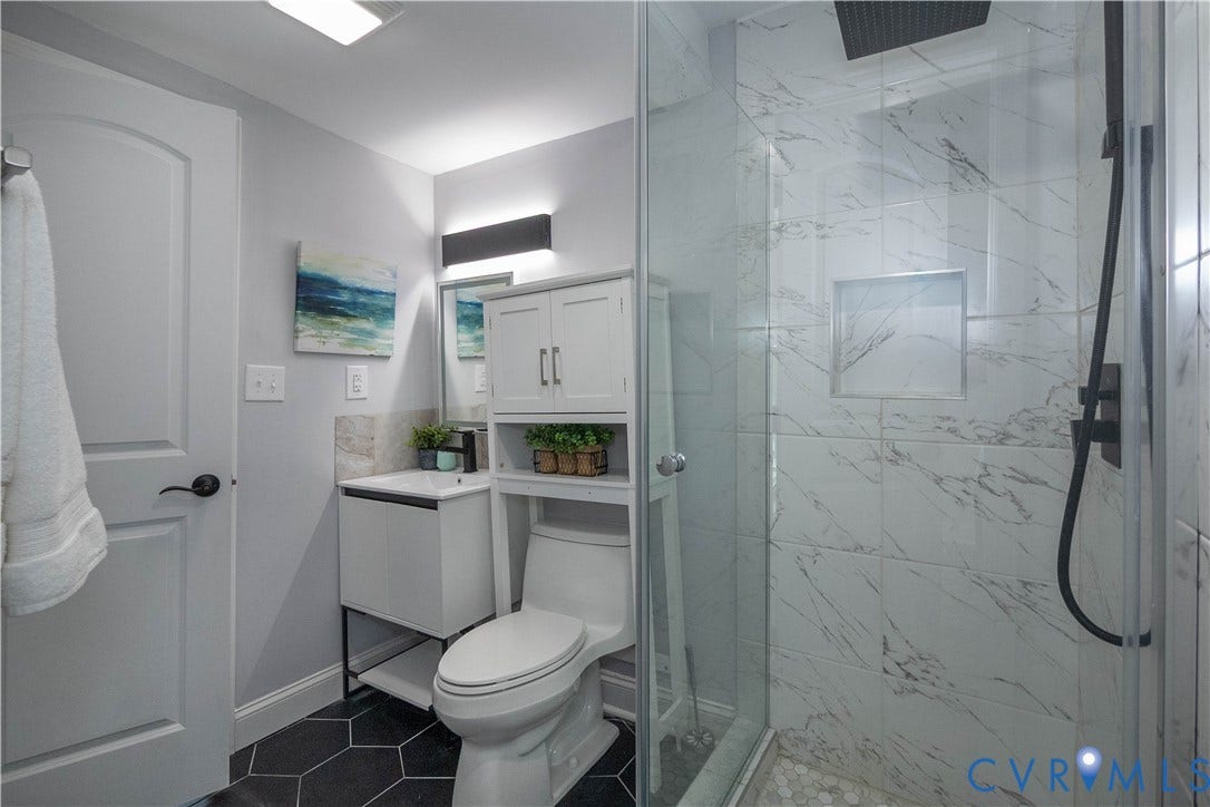 1209 N 22nd Street, Church Hill, Richmond, VA 23223 Bathroom featuring a glass-enclosed shower with tiled walls and a recessed niche