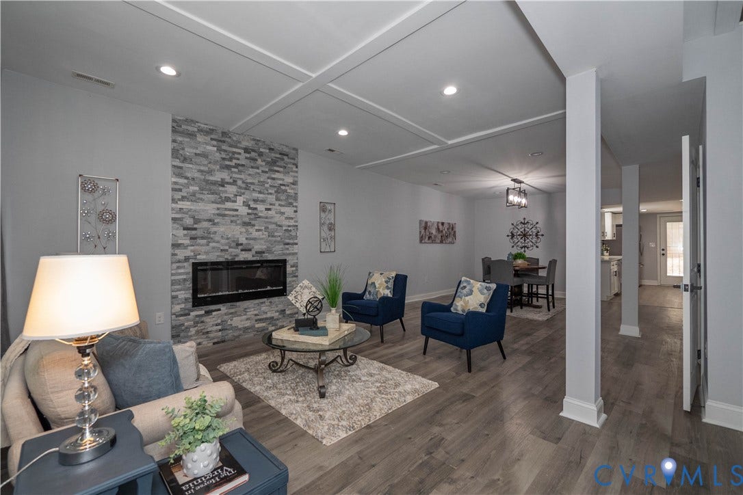 1209 N 22nd Street, Church Hill, Richmond, VA 23223 Living area featuring a floor-to-ceiling stacked stone fireplace with an electric insert, coffered ceiling, recessed lighting, and wood-finish flooring