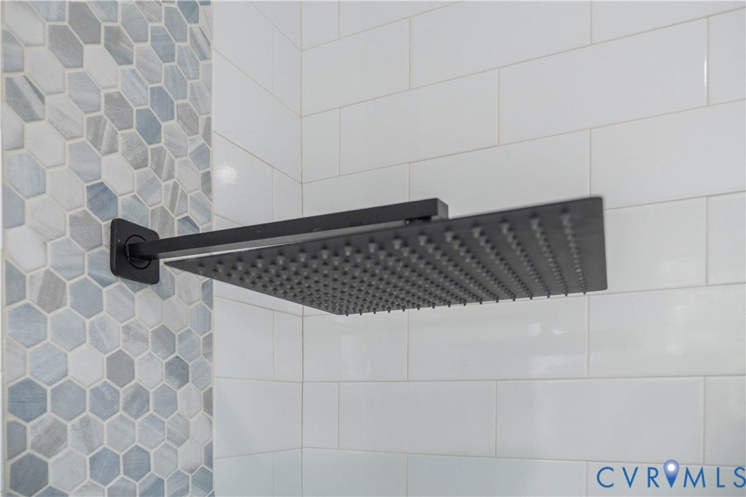 1209 N 22nd Street, Church Hill, Richmond, VA 23223 Matte black rain shower head with hexagonal accent tiling and white subway tile surround