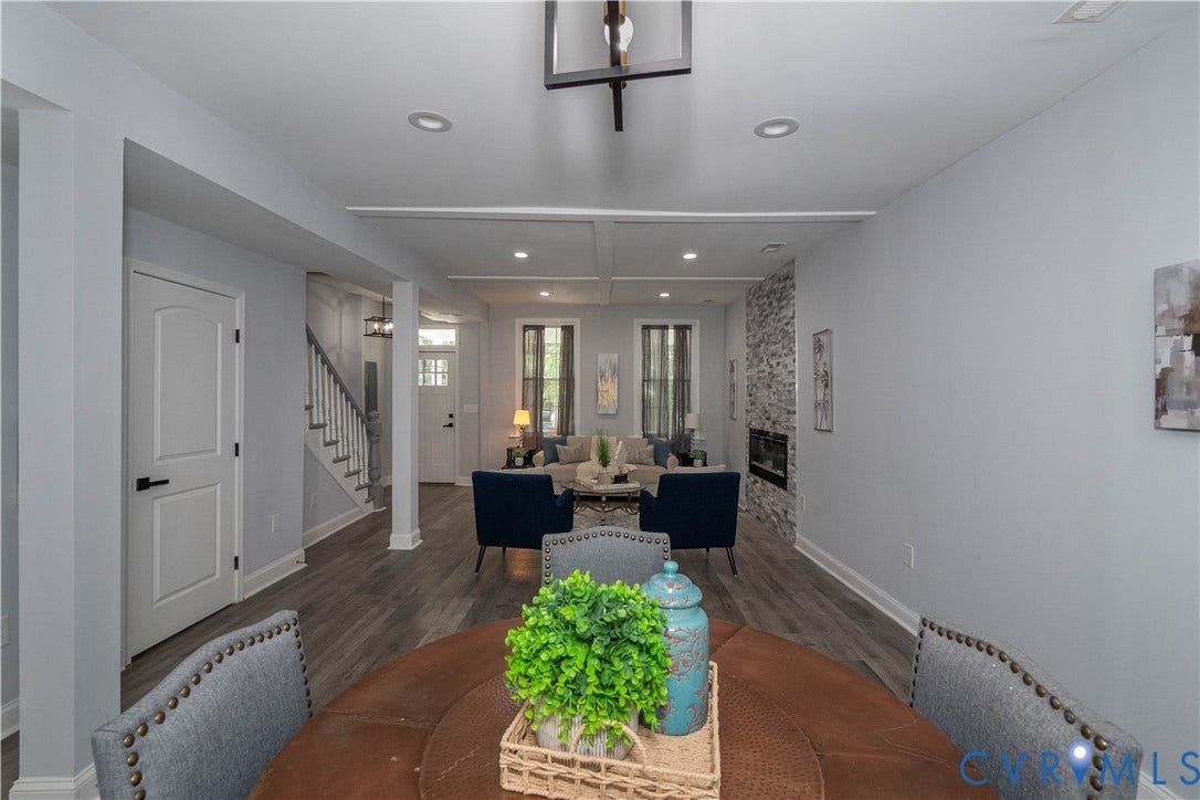 1209 N 22nd Street, Church Hill, Richmond, VA 23223 Open-concept interior featuring wood-finish flooring, recessed lighting, a stone-clad fireplace with an electric insert, and a staircase with a dark wood handrail