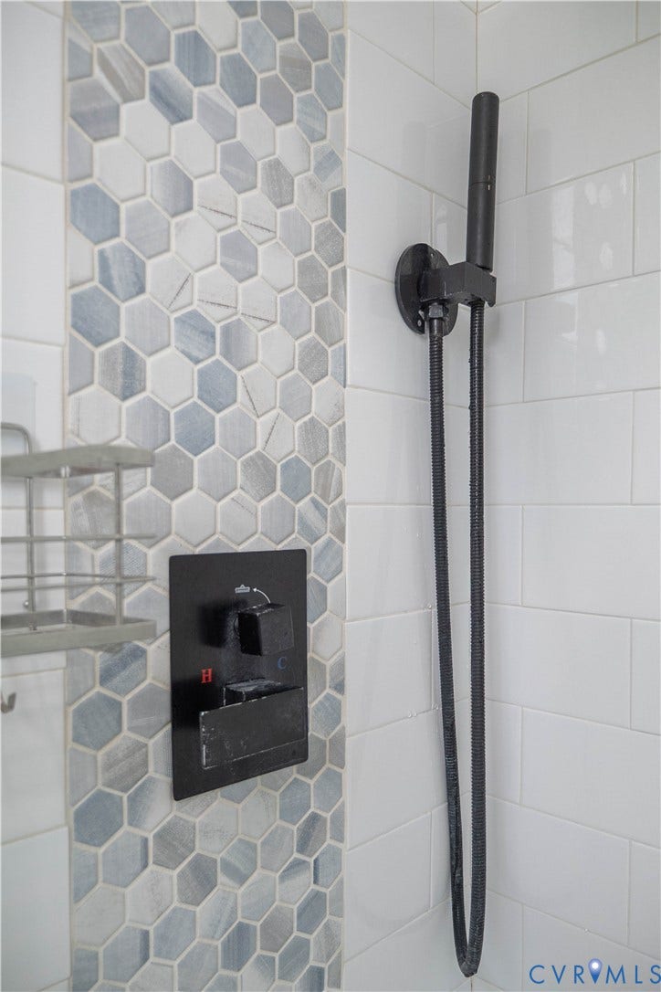 1209 N 22nd Street, Church Hill, Richmond, VA 23223 Shower featuring decorative hexagon tile accent, matte black fixtures, and white subway tile surround