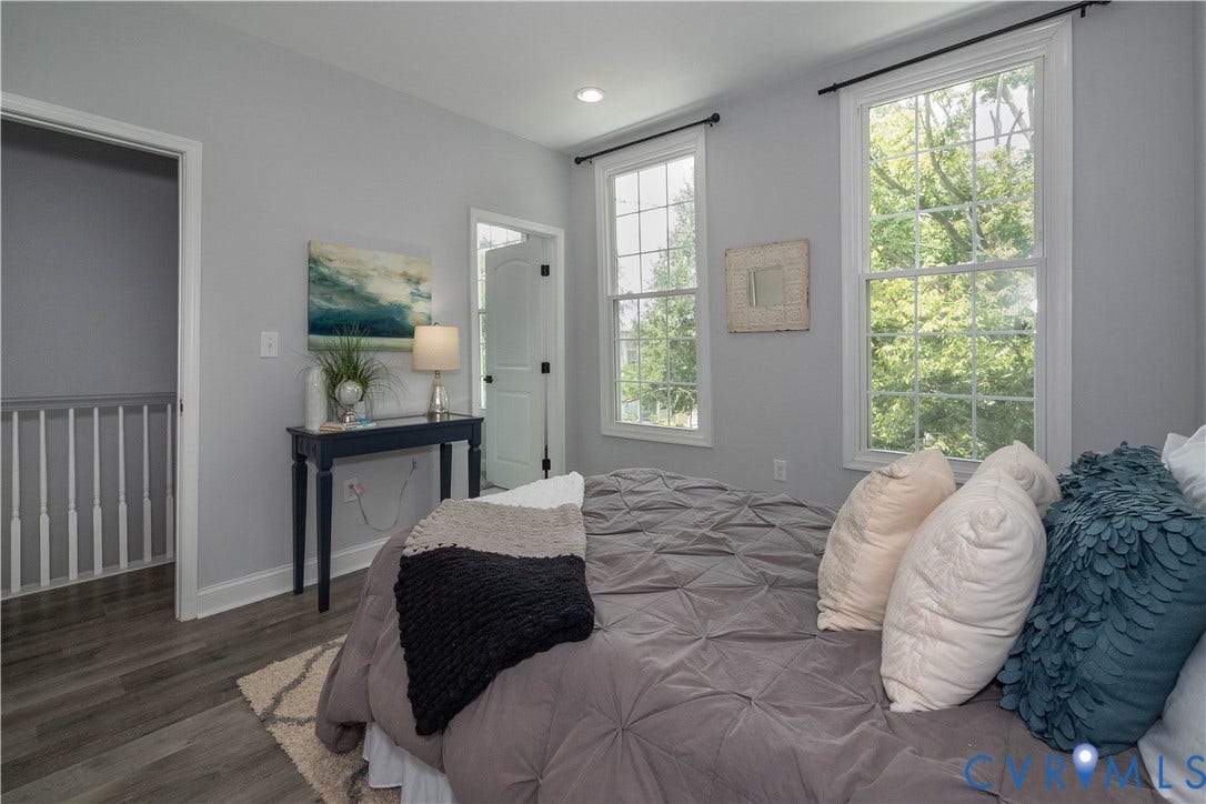 1209 N 22nd Street, Church Hill, Richmond, VA 23223 Two tall windows with white trim, wood-finish flooring, and light gray walls