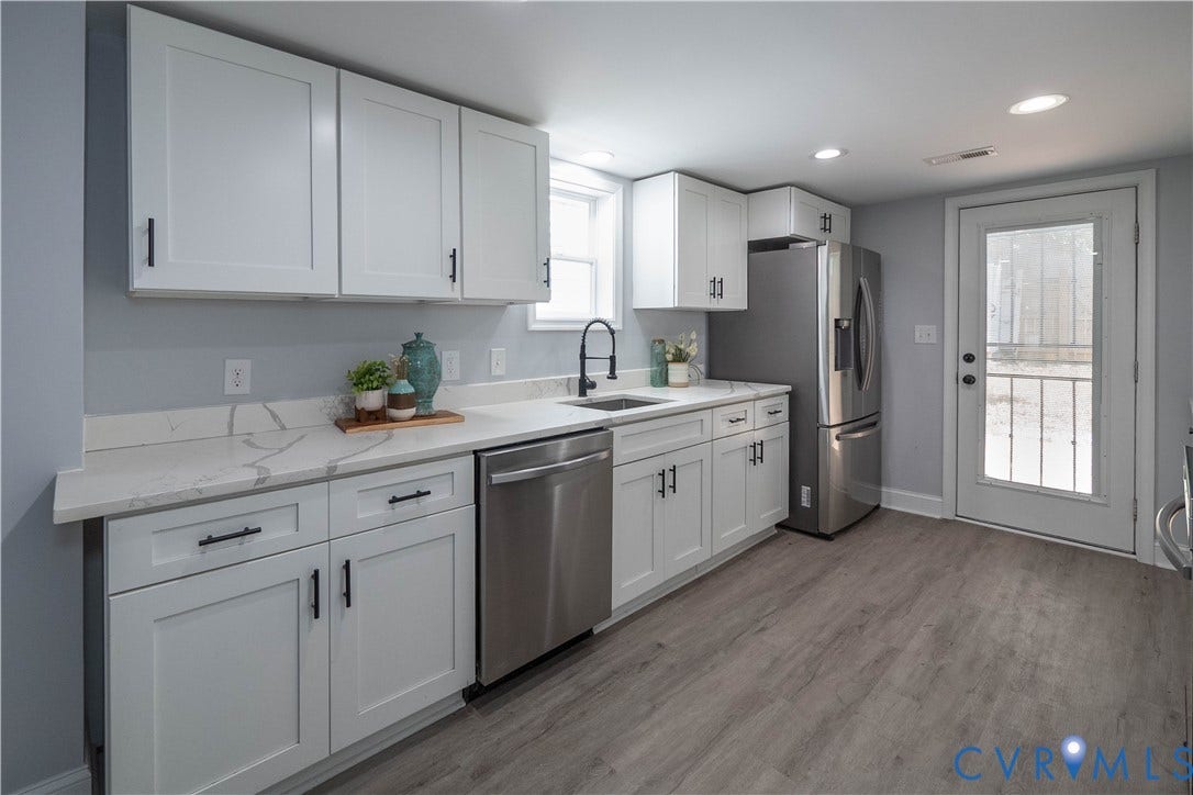 1209 N 22nd Street, Church Hill, Richmond, VA 23223 Kitchen featuring white shaker-style cabinetry, matte black hardware, stainless steel appliances, marble-look countertops, and wood-finish flooring
