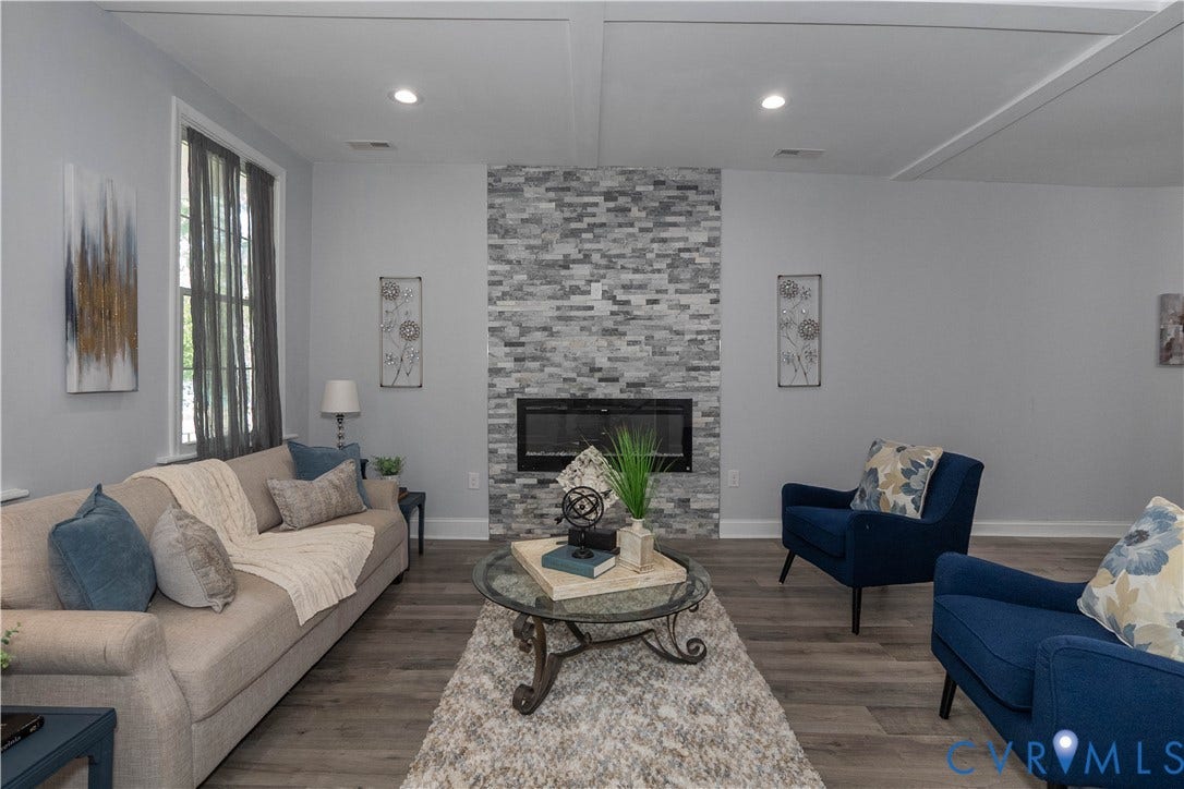 1209 N 22nd Street, Church Hill, Richmond, VA 23223 Living area featuring a floor-to-ceiling stacked stone fireplace surround with an electric insert, recessed lighting, and wood-finish flooring