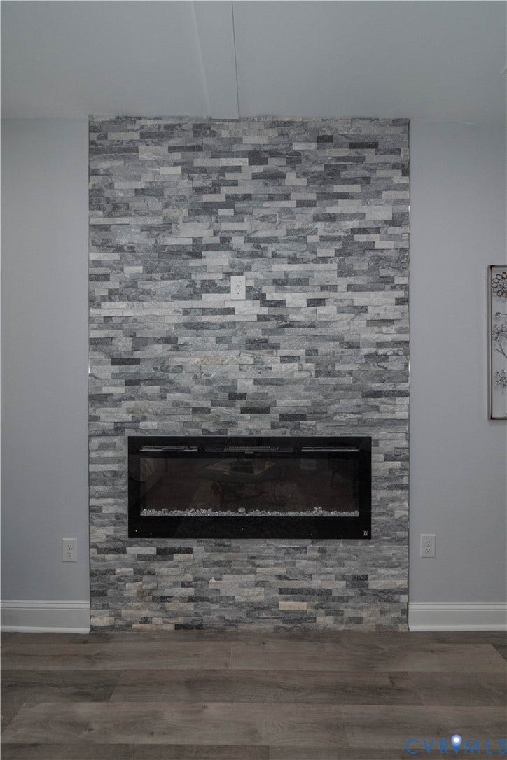 1209 N 22nd Street, Church Hill, Richmond, VA 23223 Contemporary fireplace featuring a stacked stone surround and a linear electric insert