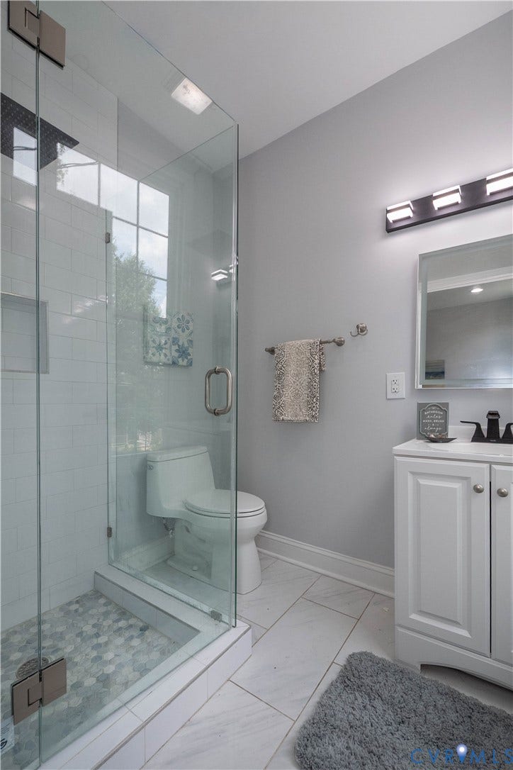 1209 N 22nd Street, Church Hill, Richmond, VA 23223 Bathroom with a glass-enclosed shower, featuring hexagonal tile flooring and subway tile walls
