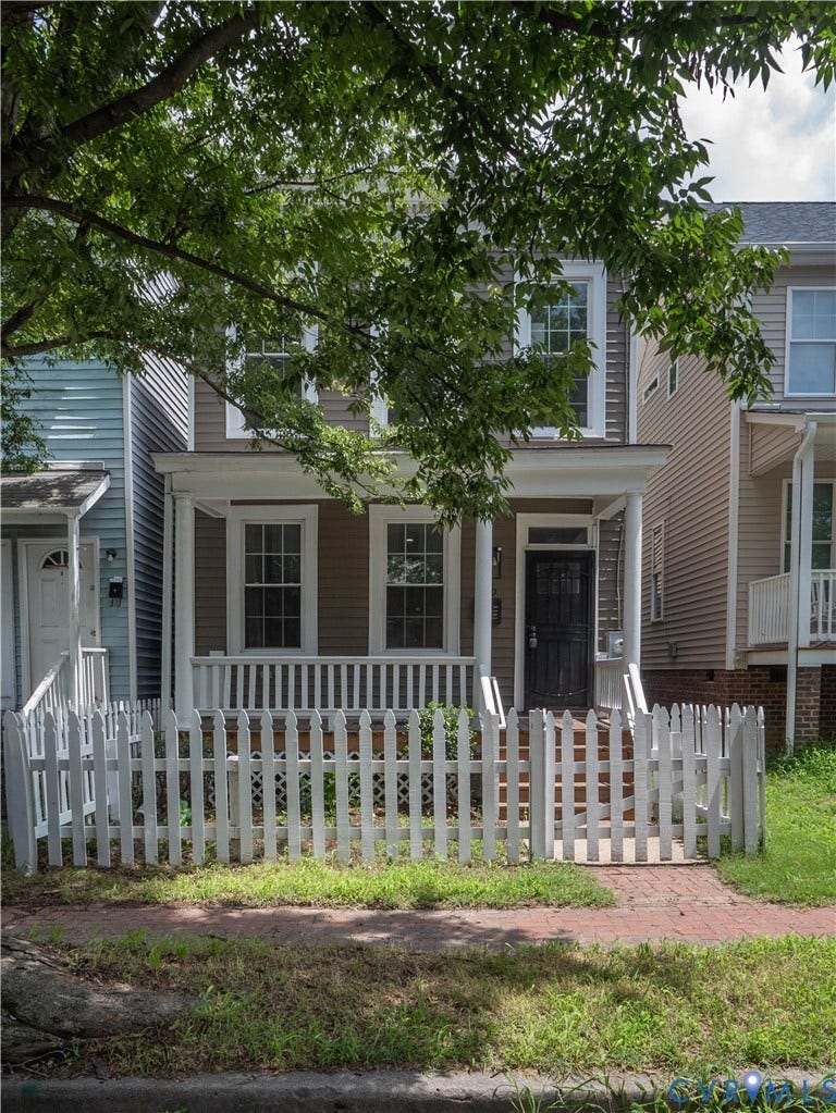1209 N 22nd Street, Church Hill, Richmond, VA 23223 Exterior featuring a covered front porch, white picket fence, and brick paver walkway