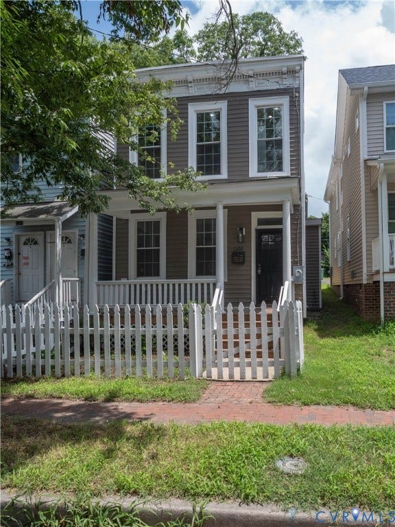 1209 N 22nd Street, Church Hill, Richmond, VA 23223 Two-story exterior with horizontal siding and white trim