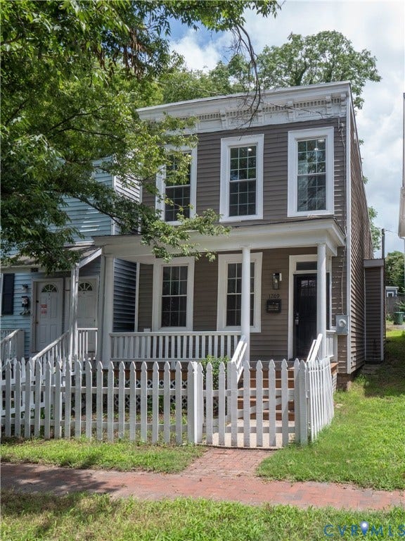1209 N 22nd Street, Church Hill, Richmond, VA 23223 Two-story home with a white picket fence, covered front porch, and brick walkway