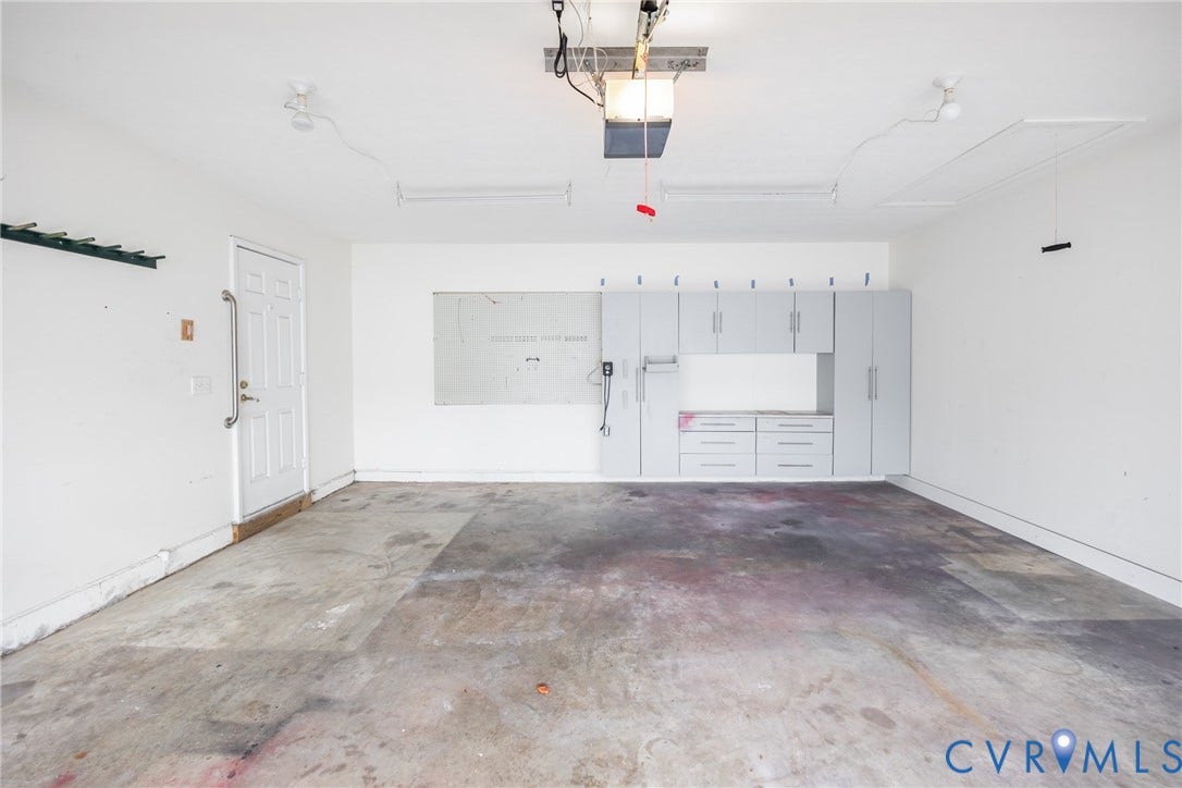 Garage interior featuring white walls and a concrete floor