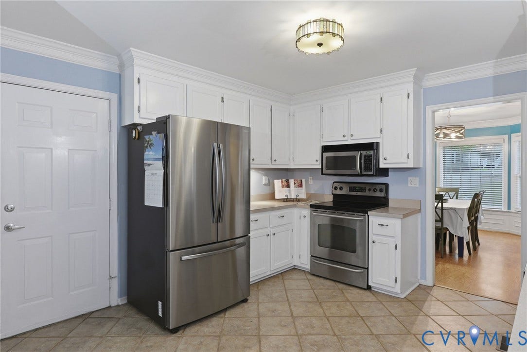 Refrigerator conveys!  Door leads to Garage
