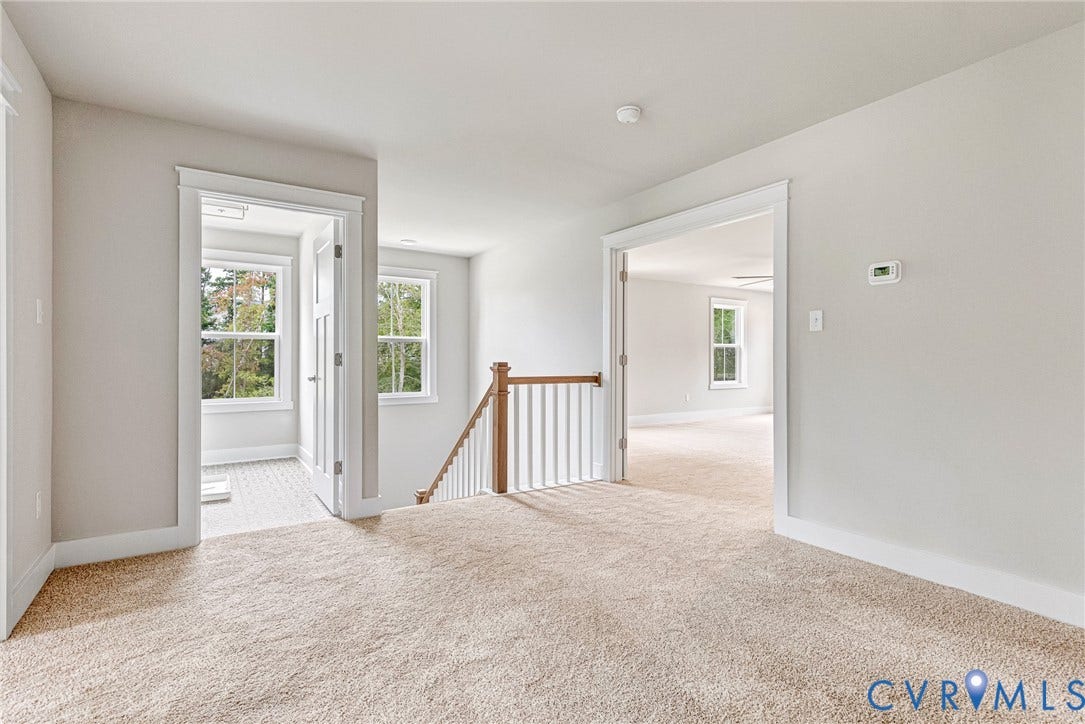 11101 Somerset Hill Drive, Somerset Hills, Glen Allen, VA 23059 Carpeted flooring, white trim details, natural wood railing, multiple windows, and a ceiling fan