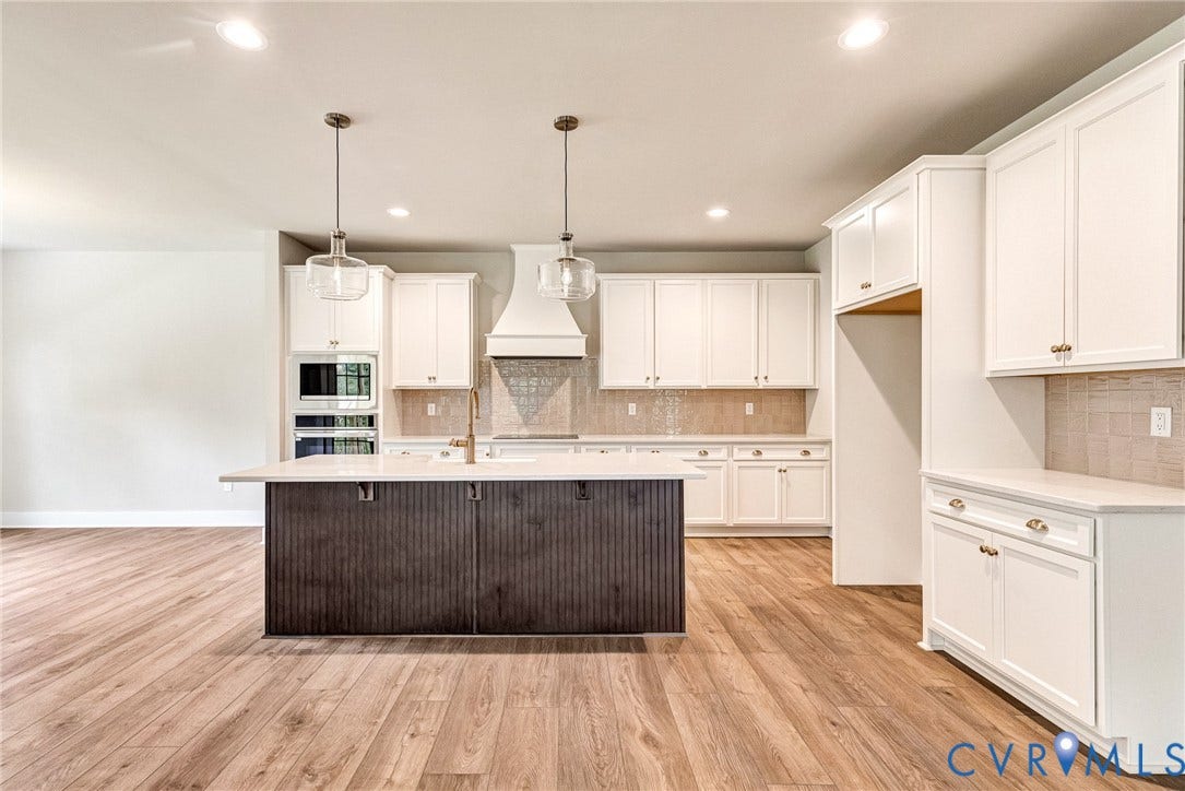 11101 Somerset Hill Drive, Somerset Hills, Glen Allen, VA 23059 Open-concept kitchen featuring wood-finish flooring, white cabinetry, a central island with a contrasting base, a tile backsplash, and recessed lighting