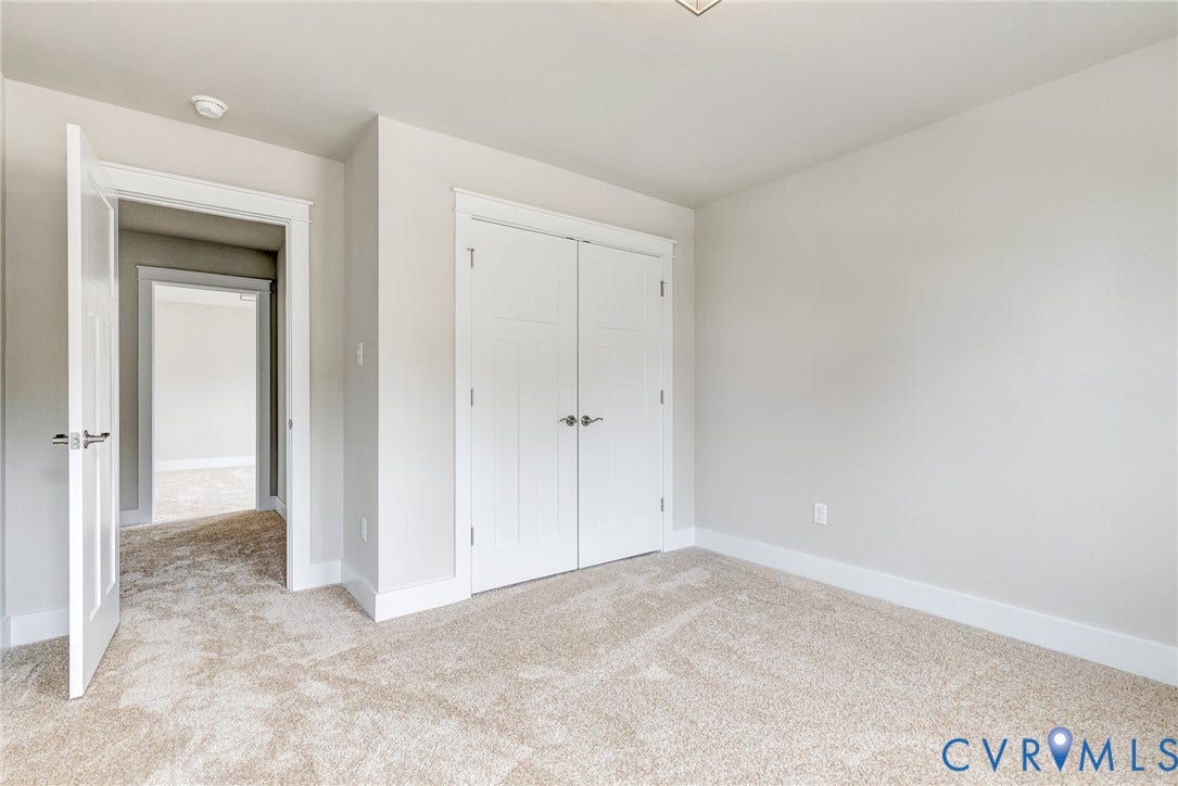 11101 Somerset Hill Drive, Somerset Hills, Glen Allen, VA 23059 Neutral wall tones, carpet flooring, a white door with contemporary hardware, and a closet with double bi-fold doors