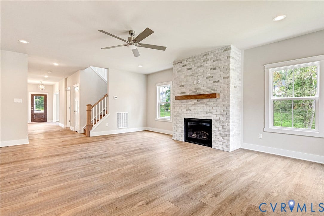 11101 Somerset Hill Drive, Somerset Hills, Glen Allen, VA 23059 Open concept living space featuring wood-finish flooring, a white brick fireplace with a wood mantle, recessed lighting, and a ceiling fan