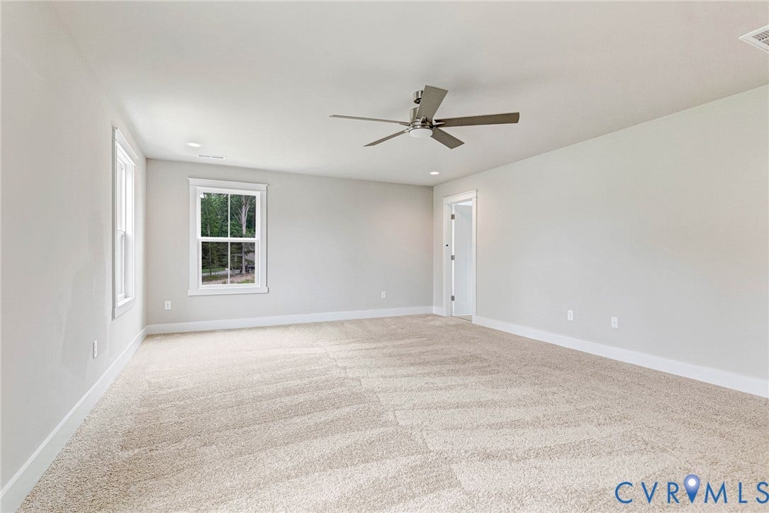 11101 Somerset Hill Drive, Somerset Hills, Glen Allen, VA 23059 Spacious room featuring neutral carpeting, recessed lighting, a modern ceiling fan, and multiple windows with white trim