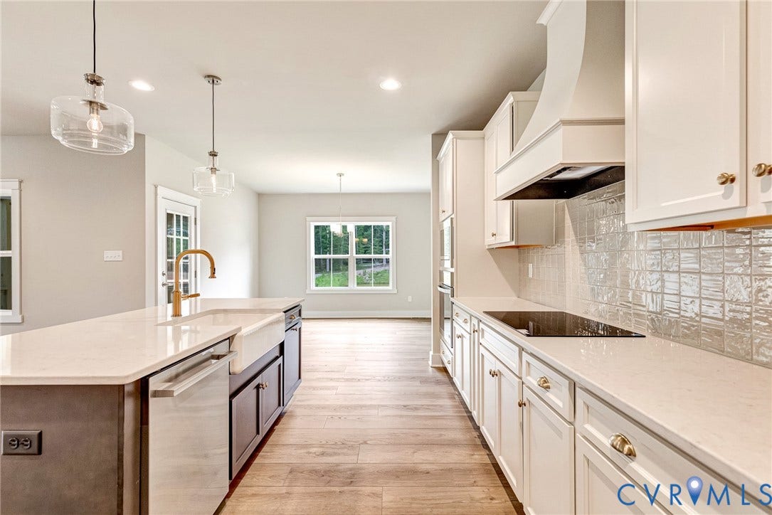 11101 Somerset Hill Drive, Somerset Hills, Glen Allen, VA 23059 Kitchen featuring white cabinetry, light-toned countertops, wood-finish flooring, a farmhouse sink with a gold-tone faucet, and a tile backsplash