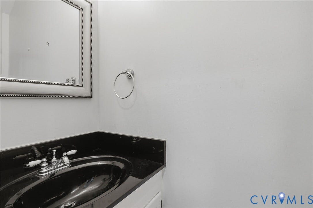 404 N Shields Avenue, Richmond, VA 23220 Bathroom vanity with a black countertop and integrated black sink