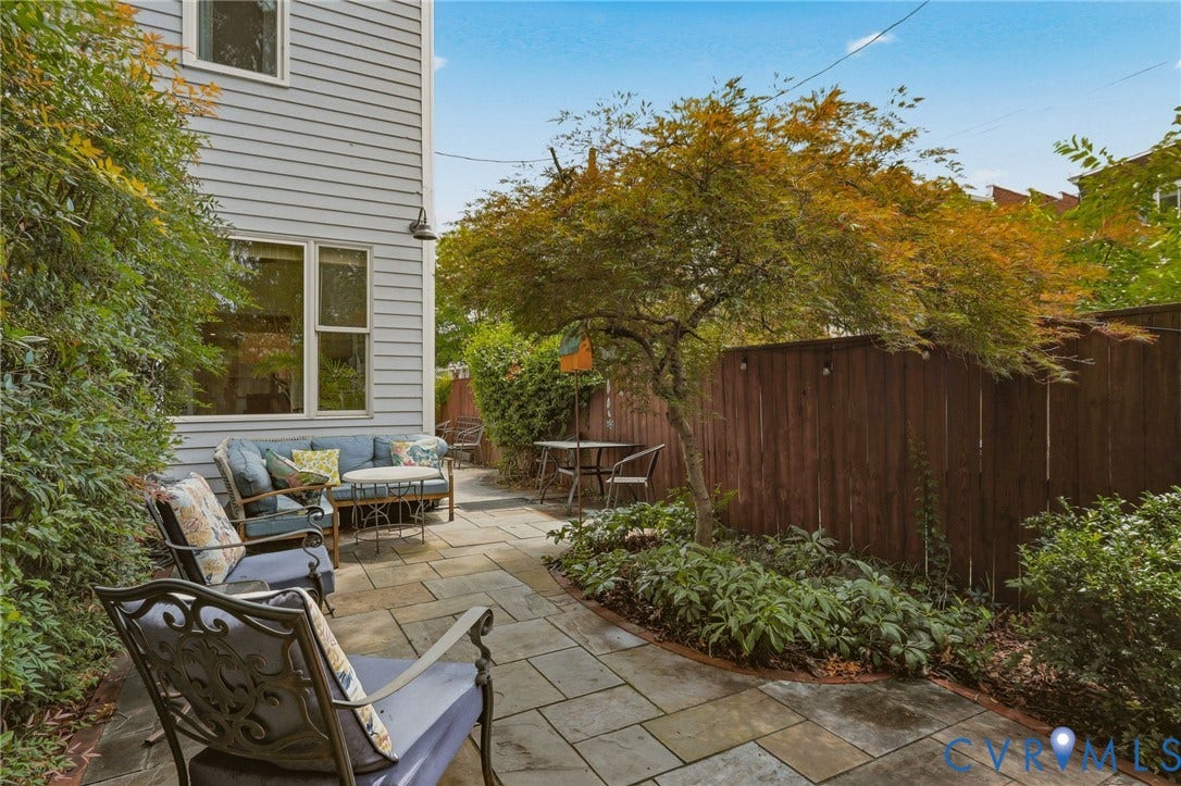 404 N Shields Avenue, Richmond, VA 23220 Spacious outdoor patio featuring flagstone paving, a privacy fence, and mature landscaping