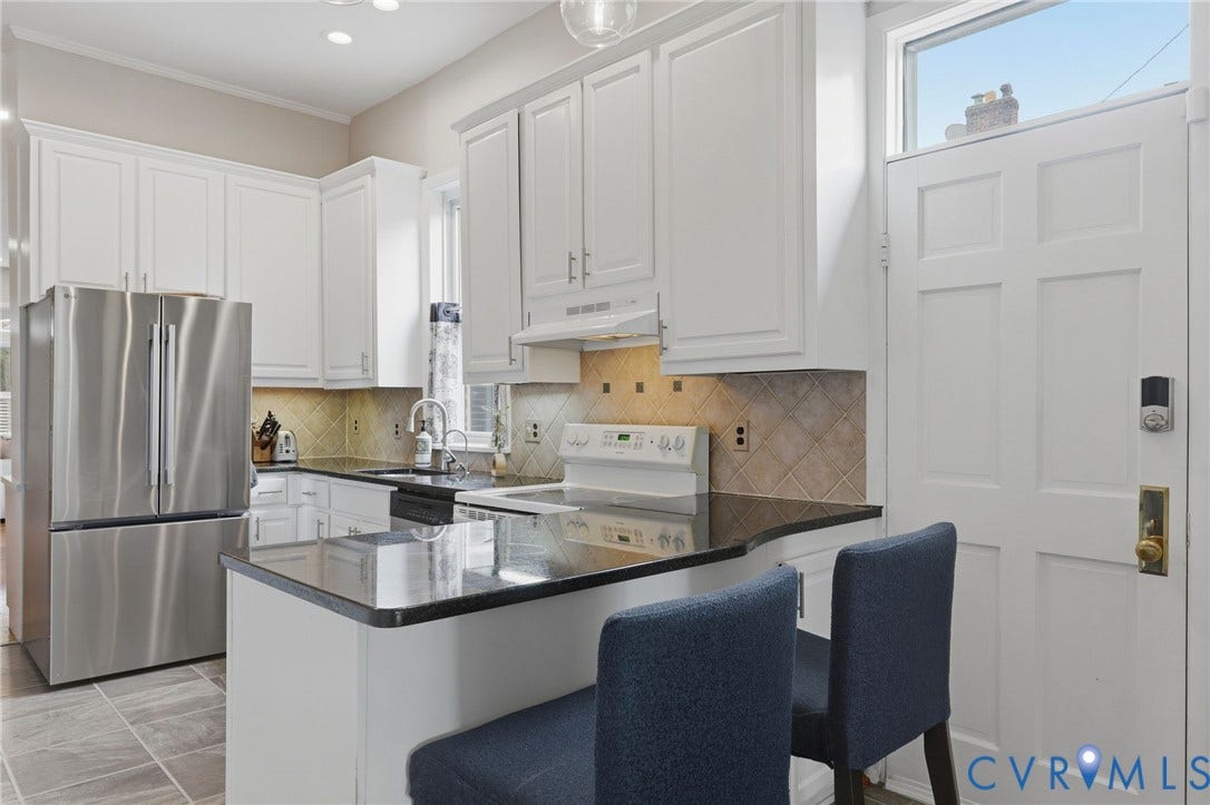 404 N Shields Avenue, Richmond, VA 23220 Kitchen featuring white cabinetry, black stone countertops, stainless steel refrigerator, tile backsplash, and tile flooring