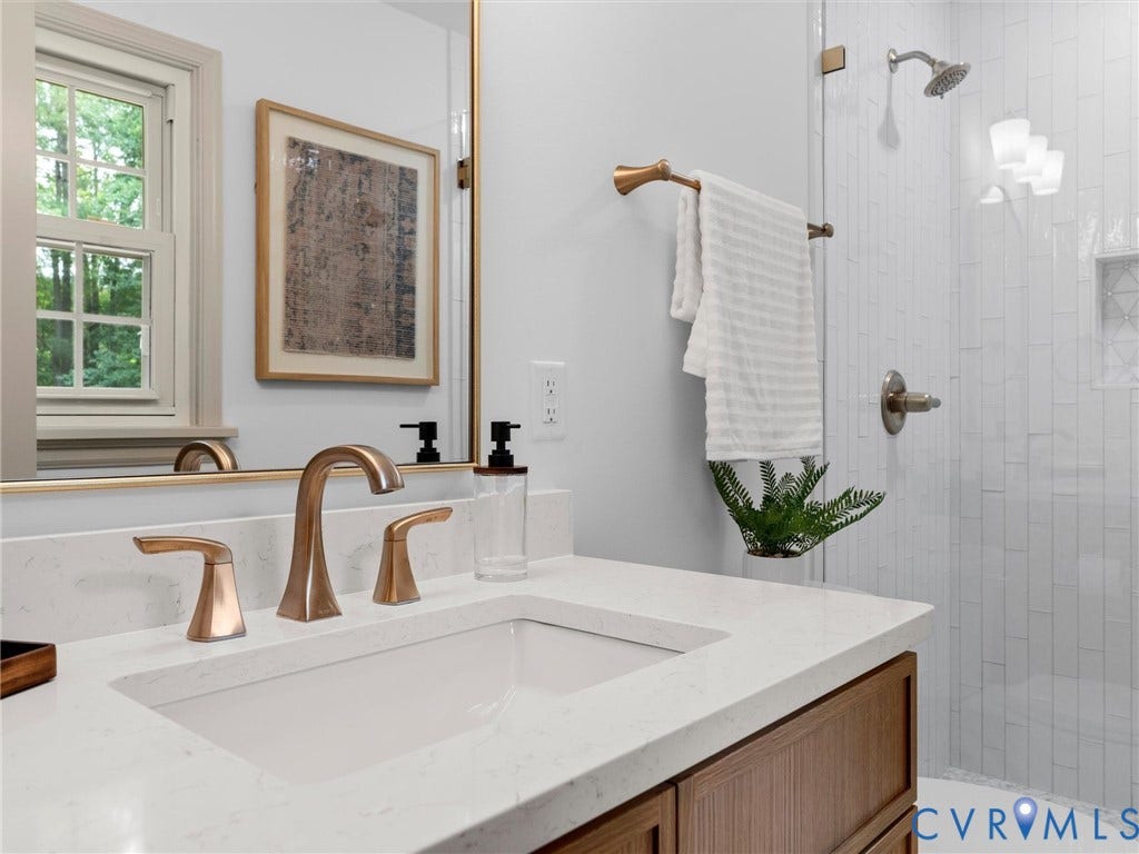 10400 Claybar Trail, Chesterfield, VA 23236 Bathroom vanity featuring a white countertop with integrated sink and bronze-finish faucet