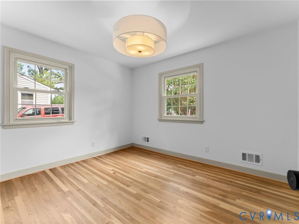 10400 Claybar Trail, Chesterfield, VA 23236 Room featuring light wood-finish flooring, two large windows, a drum-style ceiling light fixture, and white wall finishes