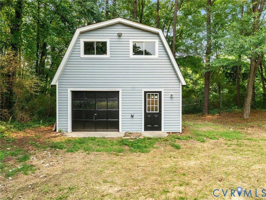10400 Claybar Trail, Chesterfield, VA 23236 Two-story garage work shop featuring light blue siding and a gambrel roofline